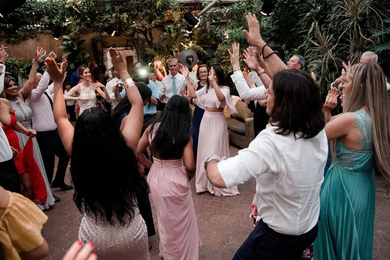 Guests celebrating with raised hands at an evening event